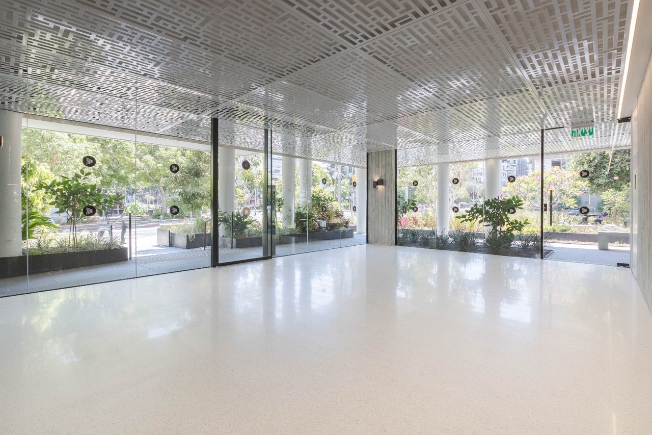 Ground floor lobby with glass walls and greenery